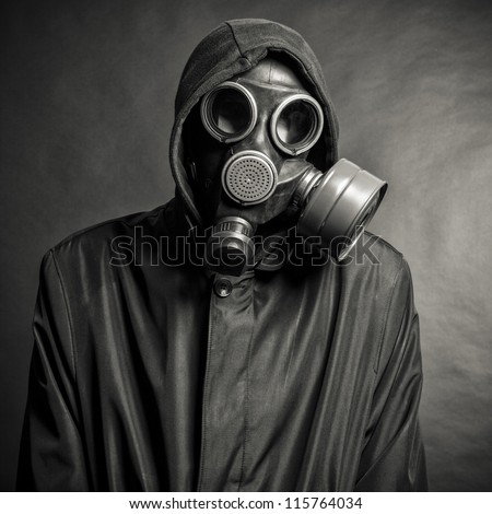 A man in a gas mask on a black background