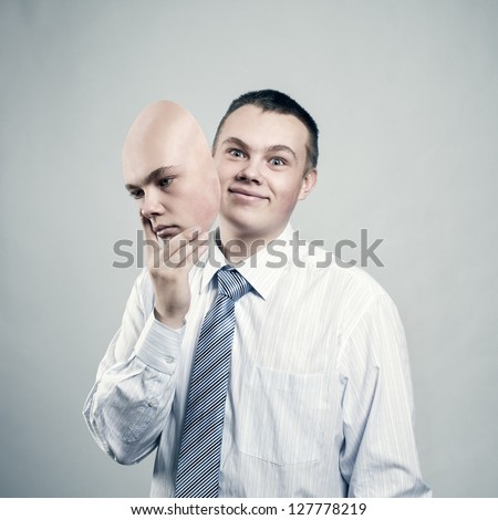 Mood changes. Businessman removes the mask from the face of a bad mood