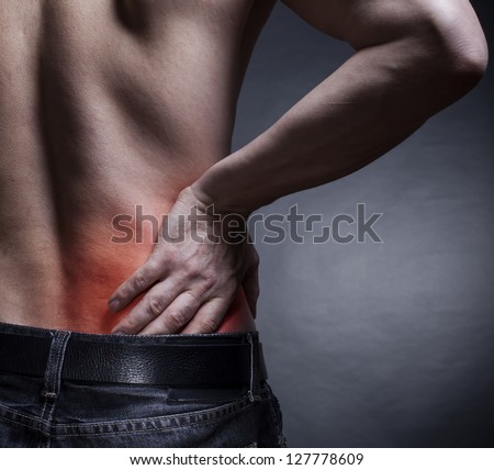 Backache. Pain in the lower back. Man's back