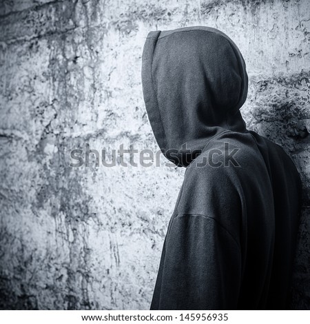 Man in a hooded sweatshirt. View from the back
