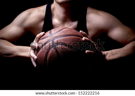 An athlete getting ready to throw a basketball into the basketball hoop