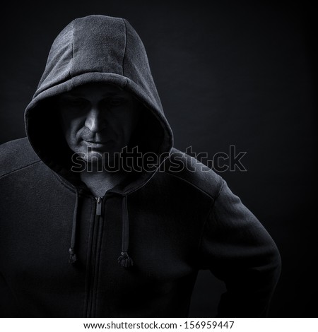 man in a hood on a black background