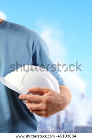 The strong hand holds a protective helmet