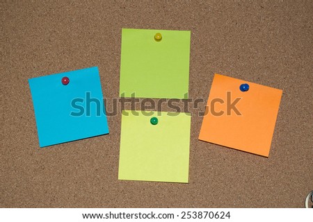 Multi Coloured Post it Notes on a Cork Board