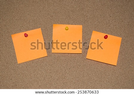 Orange Post it Notes on a Cork Board
