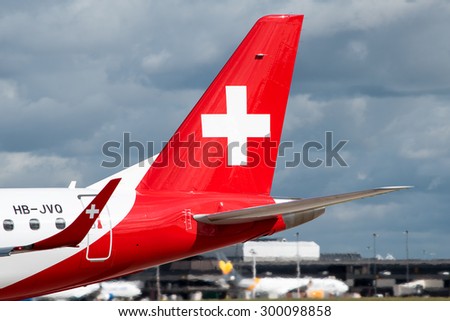 MANCHESTER, UNITED KINGDOM - JULY 18, 2015: Helvetic Airlines Embraer 190 tail livery at Manchester Airport July 18 2015.