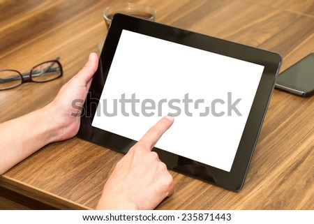 Front view of business woman working and pointing tablet with blank, white screen.