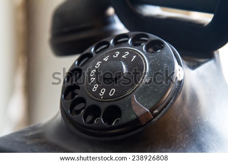 Close up view of black and dirty rotary phone.