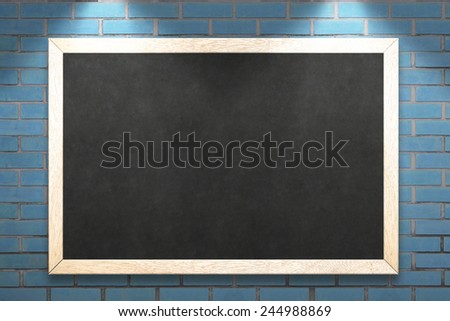 blackboard on the blue brick wall background