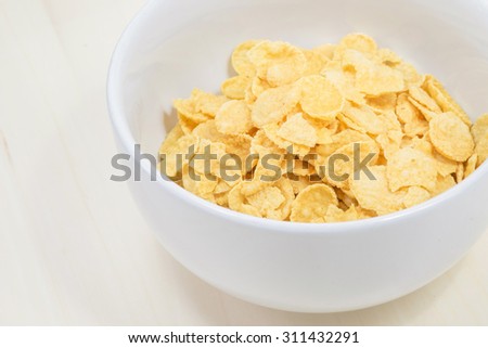 Corn flakes breakfast cereal in a white bowl