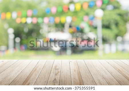 Empty wooden table with blurred party on background