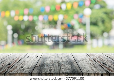 Empty wooden table with blurred party on background