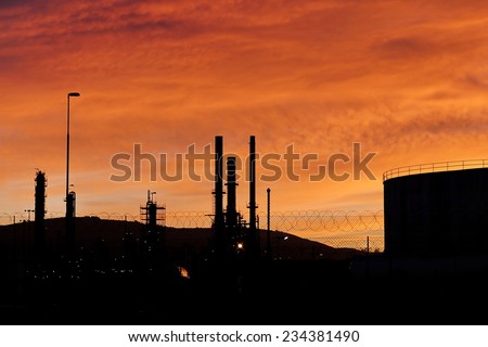 sunset sky over a petroleum refinery
