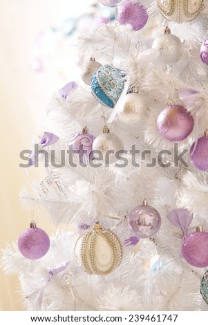 Christmas tree decorated with toys, holiday gifts. Beautiful a silver Christmas tree. New Year, decoration holiday concept where there are gifts. Christmas decorations close up.