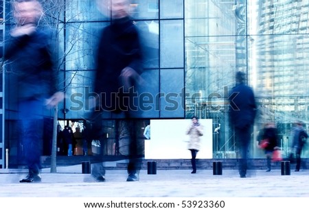 walking business people rushing on the street in motion blur