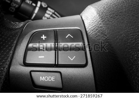 Volume and telephone command, Close up image of steering wheel of modern car, black and white