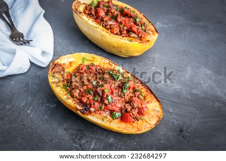 Stuffed Spaghetti squash with ground beef tomatoes and seasoning. Topped with parsley