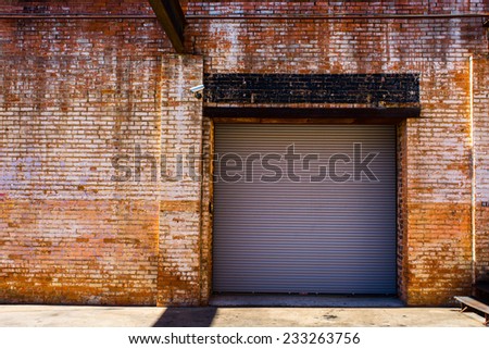 Roll-up warehouse door in a red brick building