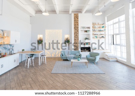 Fashionable spacious apartment with a stylish design in green, grey and white pastel colors with big window and decorative walls