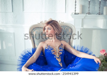 ballet dancer in blue tutu trainers in a light luxury interior
