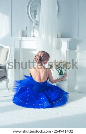 ballet dancer in blue tutu trainers in a light luxury interior