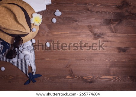 things on a dark wooden table background. vacation in the south. pebbles, stones. beach accessories. swimsuit, mask and snorkel diving, Sunglasses, sunscreen, phone, headphones. listen to music, relax