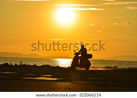 Man biker over sunset, male riding motorcycle.