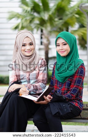 muslim girl study with her friend in the park