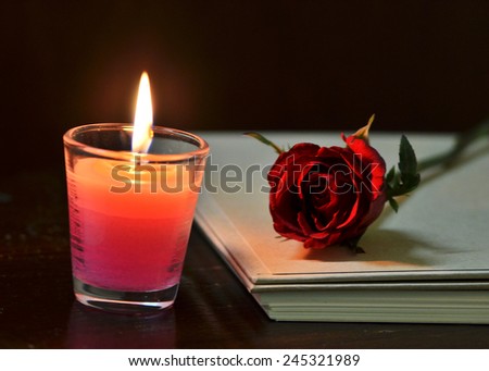 Still life rose flower and candle and diary book