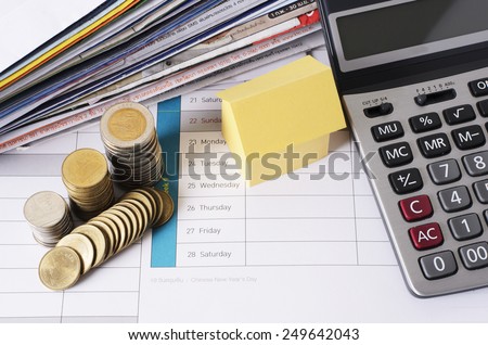 paper house and coins stack with calculator and bill payment for mortgage loans money concept