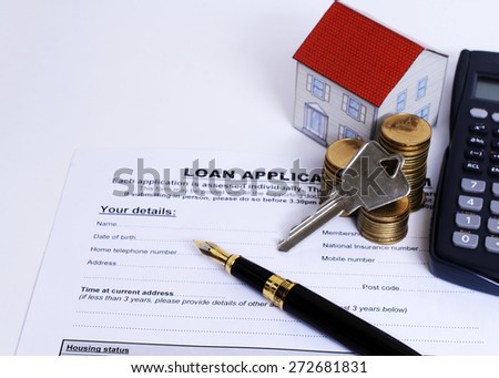 Close up home key on coins stack and paper house and calculator and fountain pen on Loan application form document