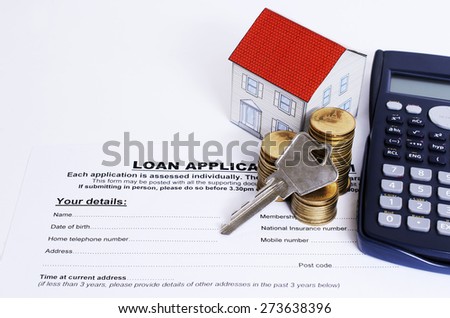 Home key with coins stack and paper house and calculator on Loan application form for Mortgage loan concept
