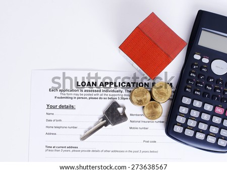 home key and coins stack and calculator and paper house on Loan application form