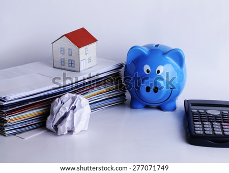mortgage loans concept with piggy bank and paper house on bill payment and calculator
