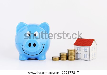 money saving plan concept with blue piggy bank and coins stack and paper house Isolated on white background