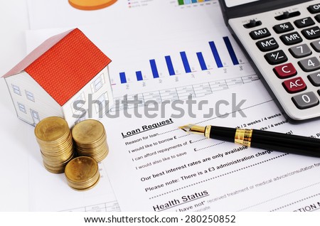 Home loans concept with close up fountain pen and loans request form and coins stack and paper house and calculate