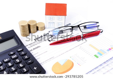 Mortgage loans concept with money coins stack and house paper wi