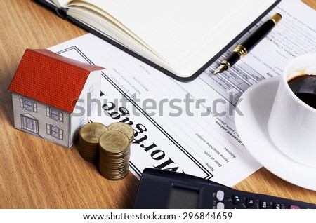 House paper and money coins stack for mortgage loans concept