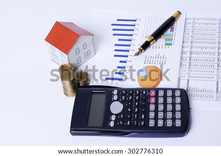 mortgage loans concept with house paper with coins stack and calculator and fountain pen on business chart