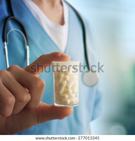 Healthcare And Medicine. Close-up of doctor holding a pill container