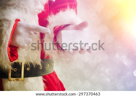 Santa Claus holding visit card