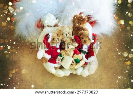 Santa holding Christmas gift bear