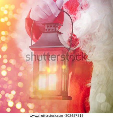 Santa Claus holding  vintage lantern