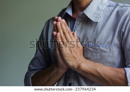 businessman hands clasped praying