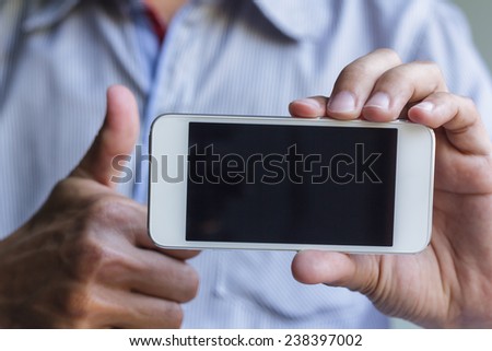 man show his smart phone, smart phone in the hand with thumb up