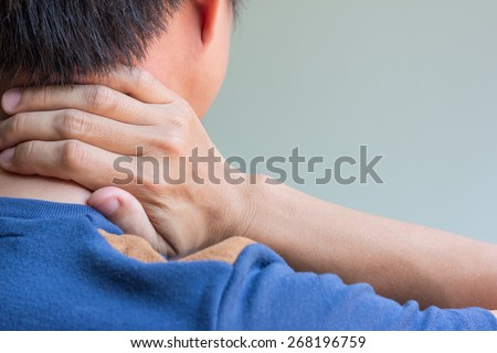 Asian man having neck pain and free space for text