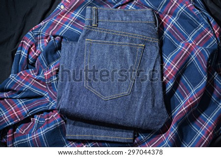 Blue Jeans Denim, 100% Cotton Un sanforized Denim Red Selvage Jeans on Plaid Shirt background, selective focus (detailed close-up shot)