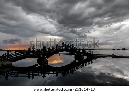 Small wooden bridge on Lefkada Island with cloudy sunset