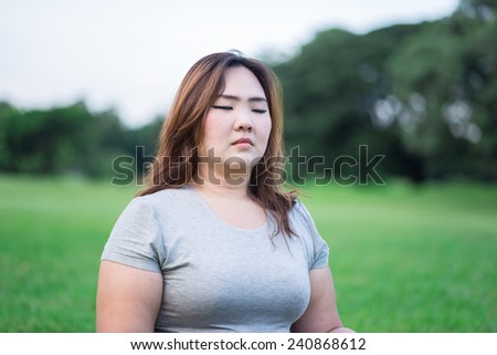 fatty woman has meditation in the garden