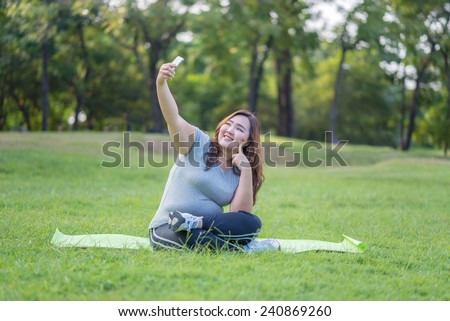 fatty woman take herself photo in the garden